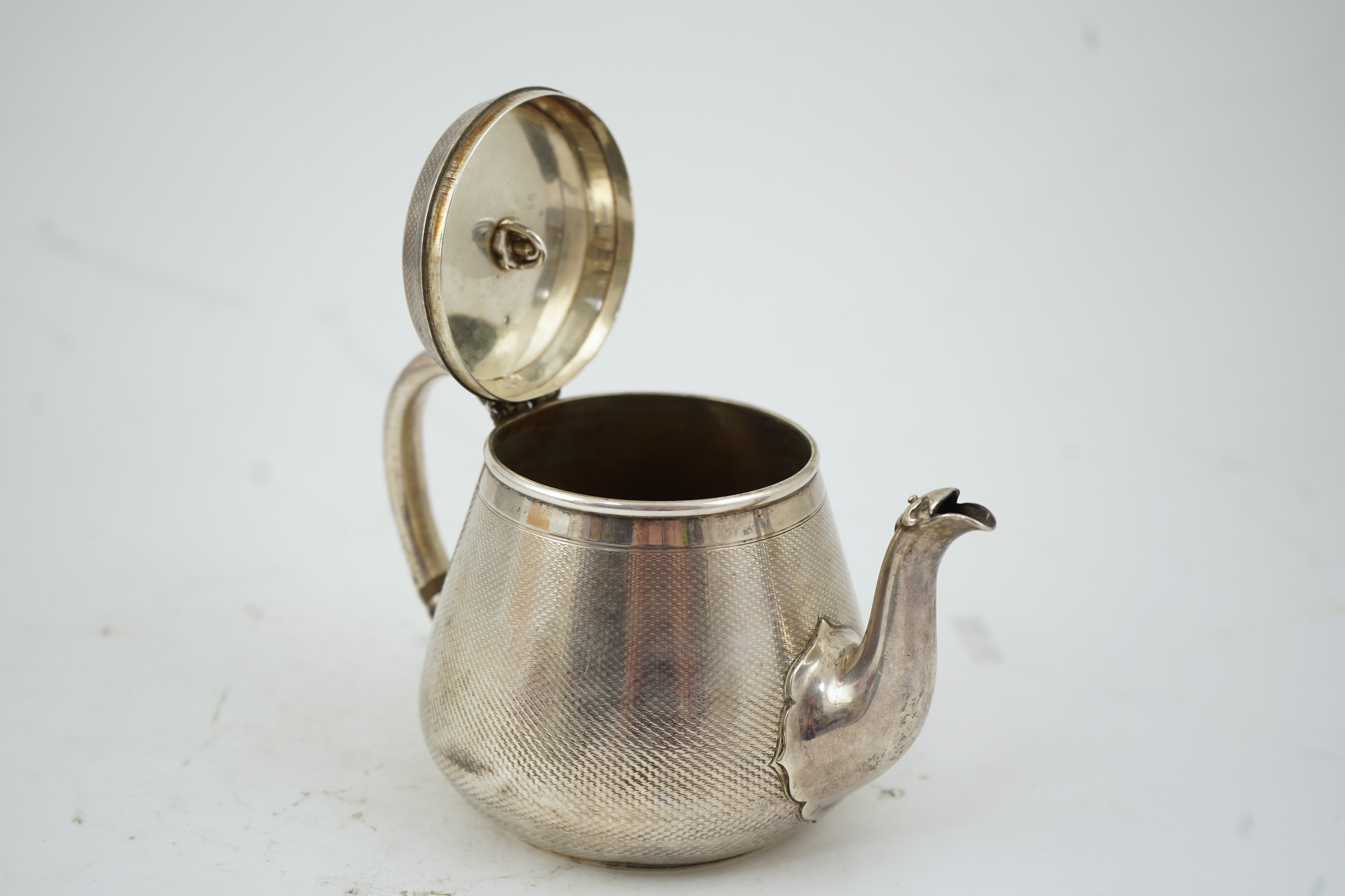 A Victorian engine turned silver teapot by Hunt & Roskell